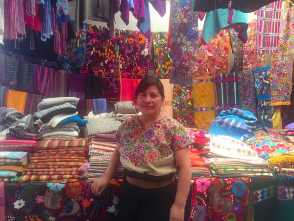 A Tzotzil Mayan woman selling her traditional textiles in Zinacantán (photo by Cayte Bosler). 